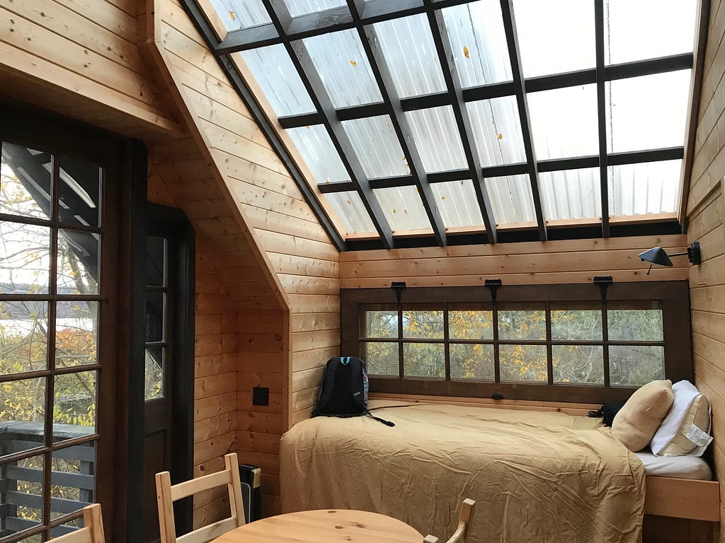 a little bed beneath a sloping skylight
