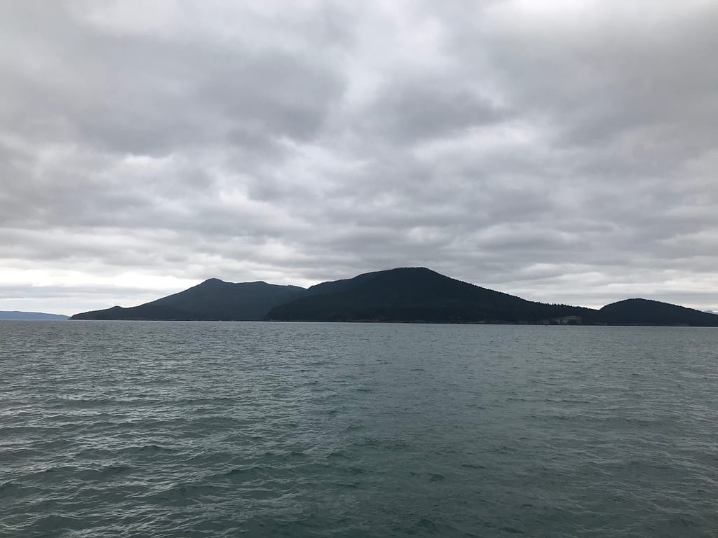 dark islands rising from the flat grey waters