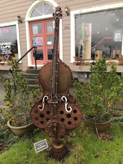 sculpture of a double bass instrument outside a music store