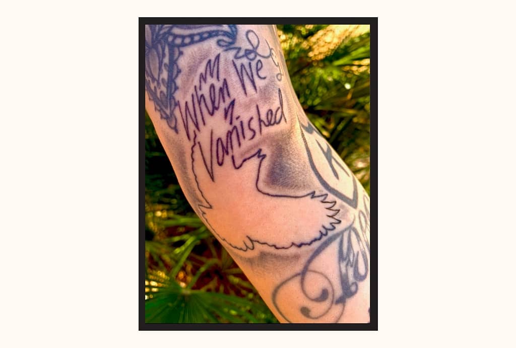 a tattoo version of the When We Vanished cover. An outlined crow silhouette with the same handwritten lettering from the cover that reads "When We Vanished."
