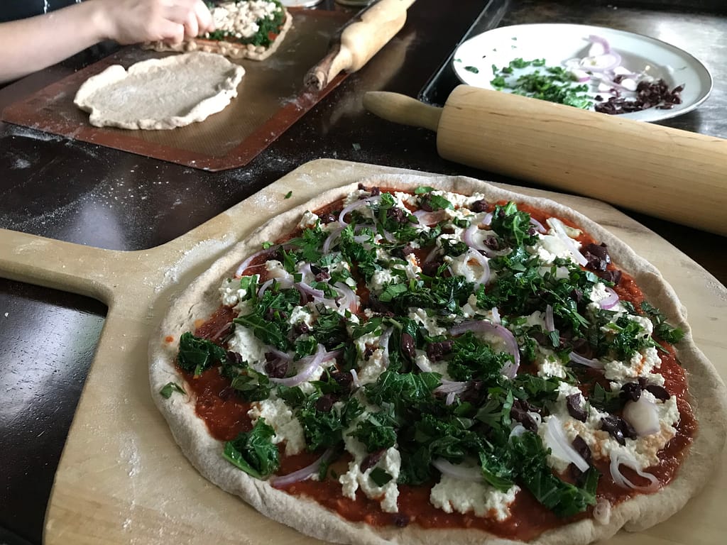 pizzas being assembled