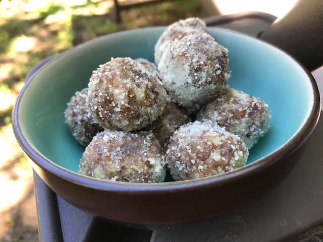 Date-tahini energy bites in a bowl outside in the shade