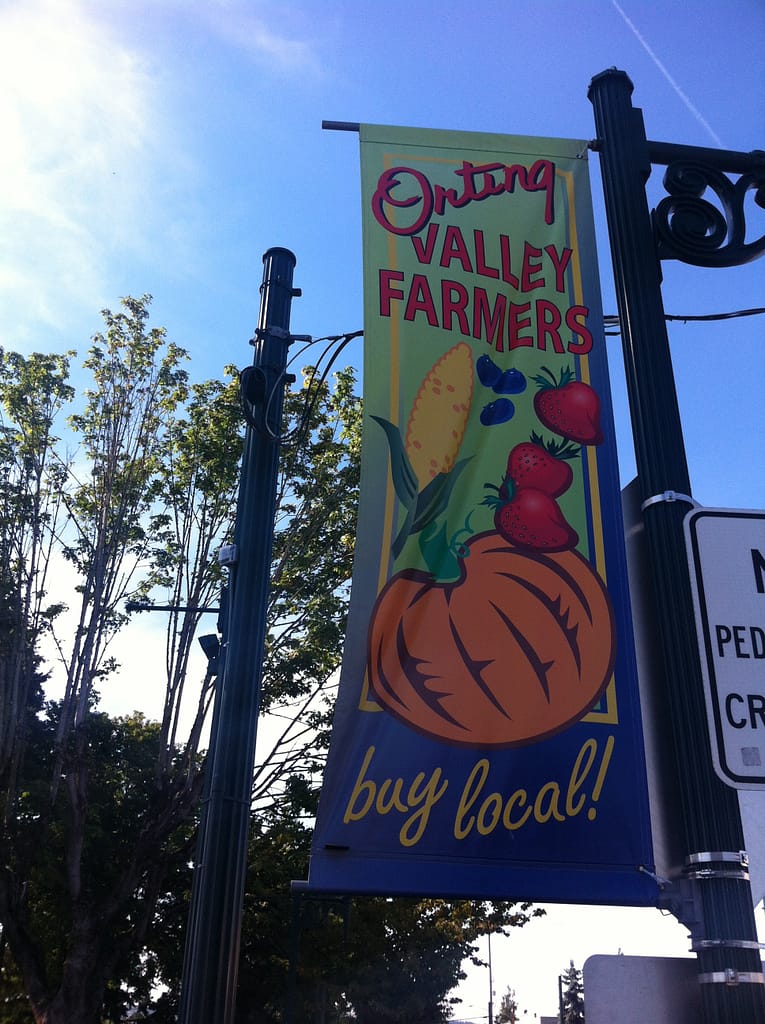 Banner on streetlight that says, "Orting Valley Farmers - Buy Local"